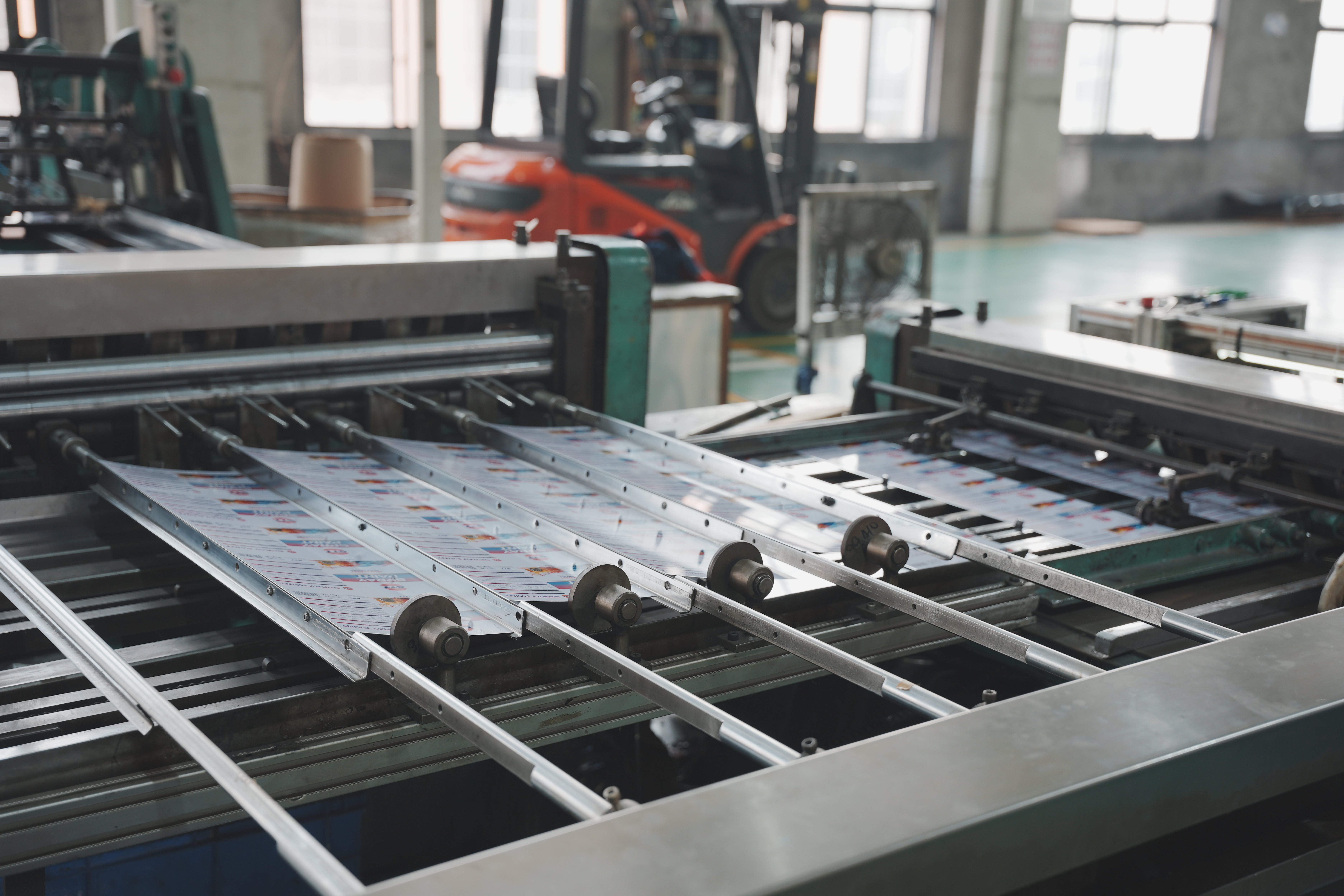 Printed tinplate sheets feeding through workshop equipment